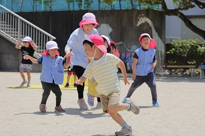 写真：年長児　友達と鬼ごっこ様子